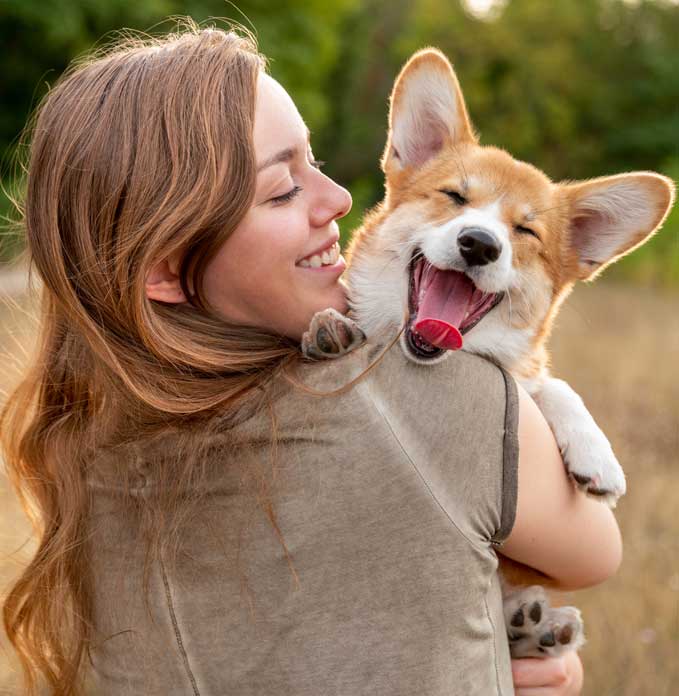 Woman hugging a yawning dog